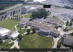 Screen grab from 2017 Summit Recap Video showing an overhead view of the JMU campus where the Summit takes place. Brown-roofed buildings with white sidewalks and green space is visible.