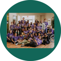 Group photo of IMD Youth Leaders after a Youth & Family Summit. They are all wearing that year's purple summit t-shirt that says, "Life Ready" and has four tools above the words.